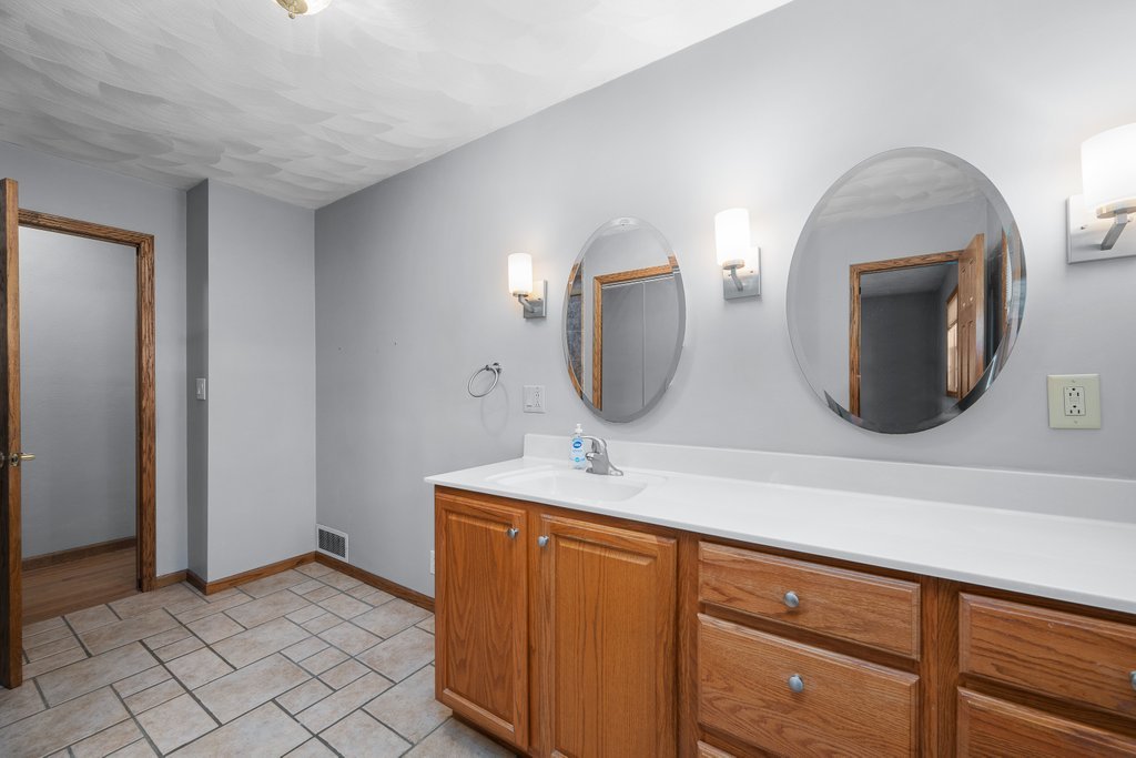 207 Amber Lane Geneseo, IL 61254 - Photo 23 of 57 a bathroom with a sink mirror and vanity