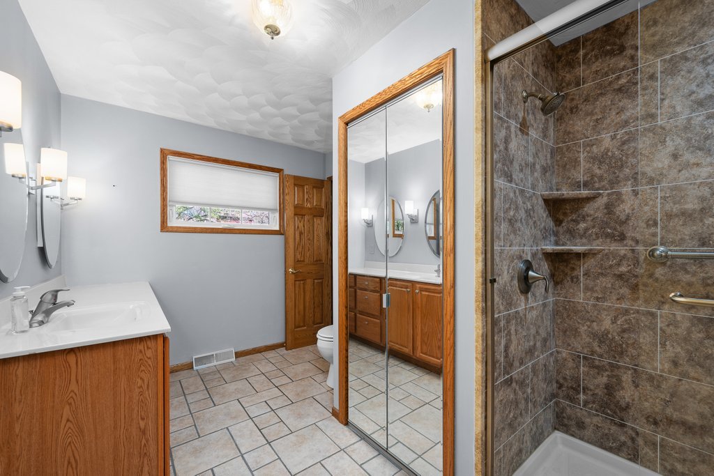 207 Amber Lane Geneseo, IL 61254 - Photo 24 of 57 a bathroom with a shower and a sink