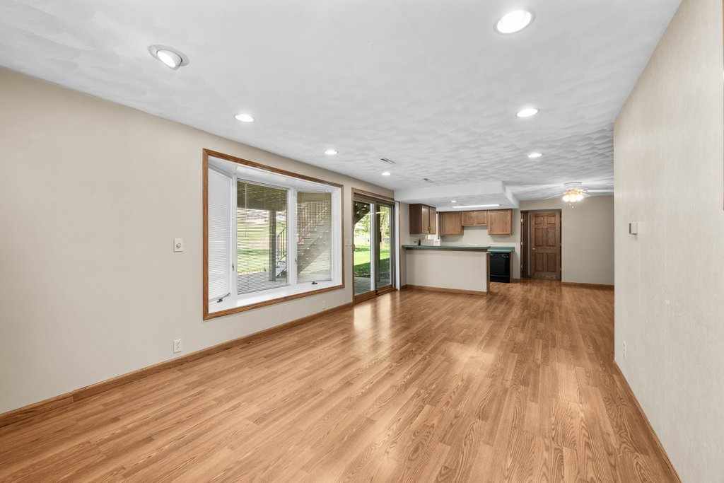 207 Amber Lane Geneseo, IL 61254 - Photo 31 of 57 a view of empty room with wooden floor and kitchen