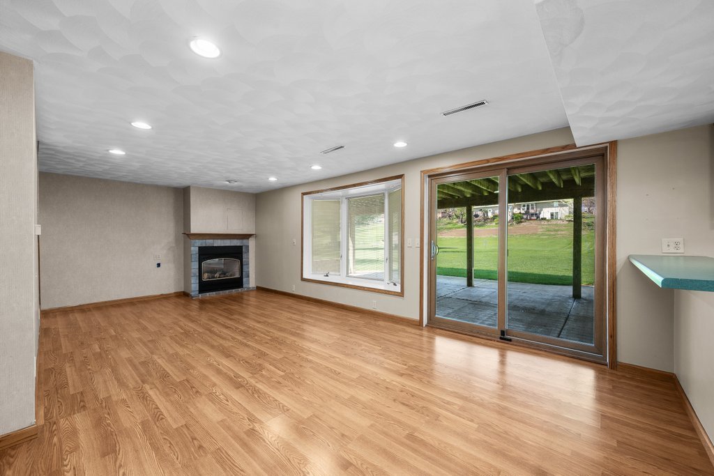 207 Amber Lane Geneseo, IL 61254 - Photo 33 of 57 a view of an empty room with wooden floor and a window