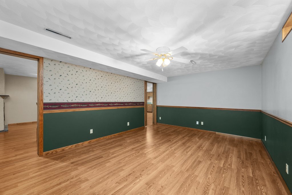 207 Amber Lane Geneseo, IL 61254 - Photo 40 of 57 a view of a room with window ceiling fan and wooden floor