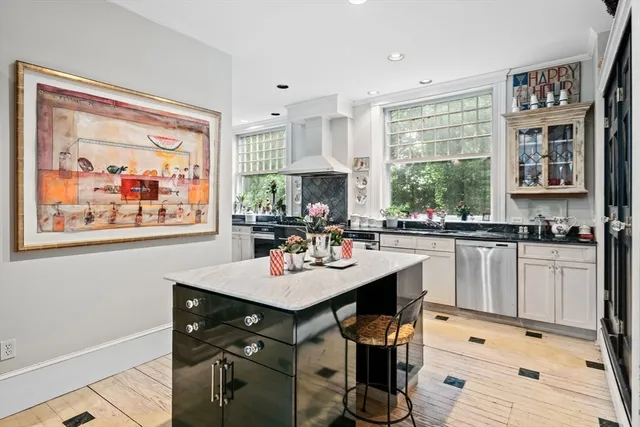 a kitchen with granite countertop a stove refrigerator and cabinets