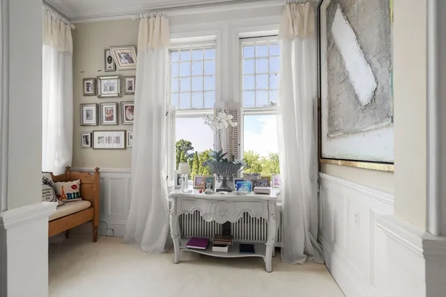 a view of a bedroom with furniture and windows