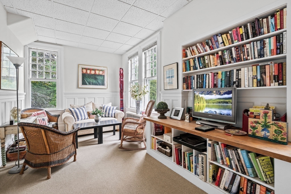51 Cliff Street Nahant, MA 01908 - Photo 24 of 42 a living room with furniture lots of books and a large window