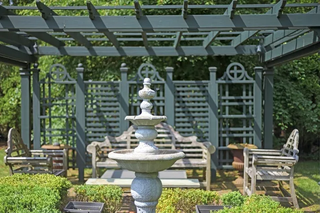 a view of house with backyard outdoor seating and green space