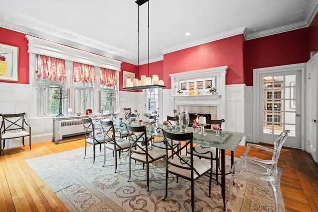a view of a dining room with furniture a chandelier and wooden floor