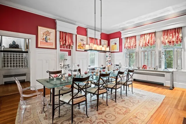 a living room with furniture a fireplace and a large window