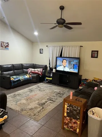 a living room with furniture a flat screen tv and a couch