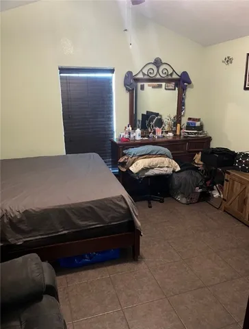 a bedroom with furniture and a chandelier