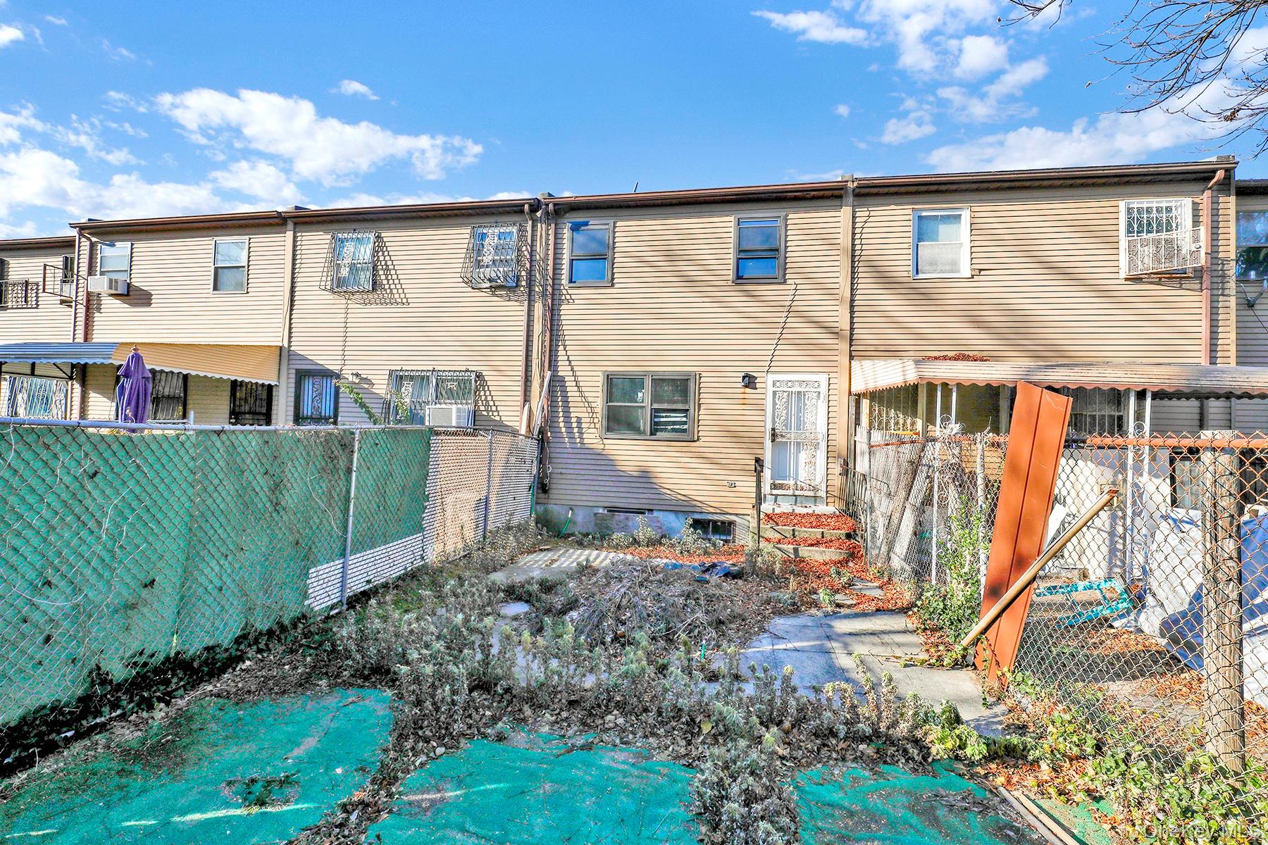 559 Cleveland Street Brooklyn, NY 11208 - Photo 31 of 34 Rear view of house with a fenced backyard
