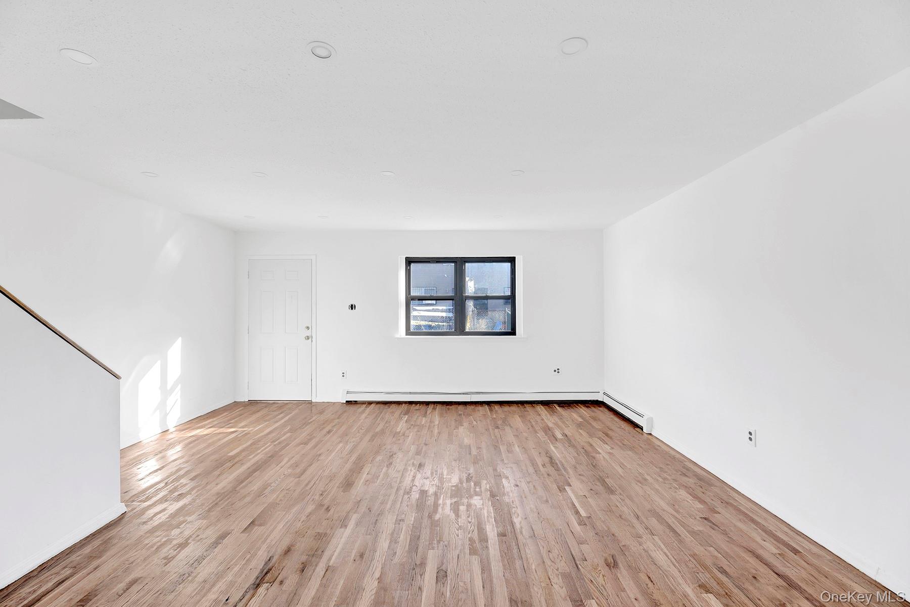 559 Cleveland Street Brooklyn, NY 11208 - Photo 8 of 34 Empty room with light wood-style floors