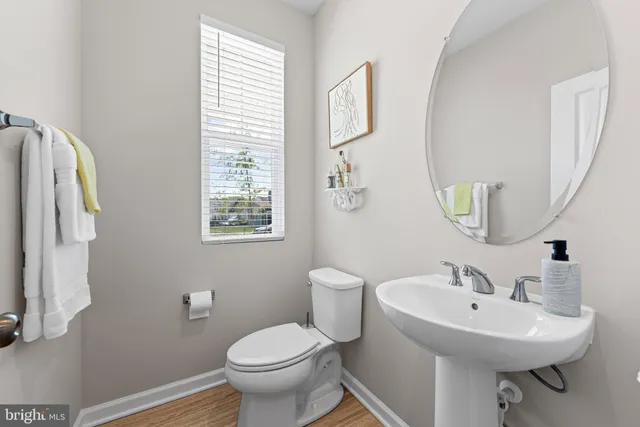 a bathroom with a sink and mirror with toilet