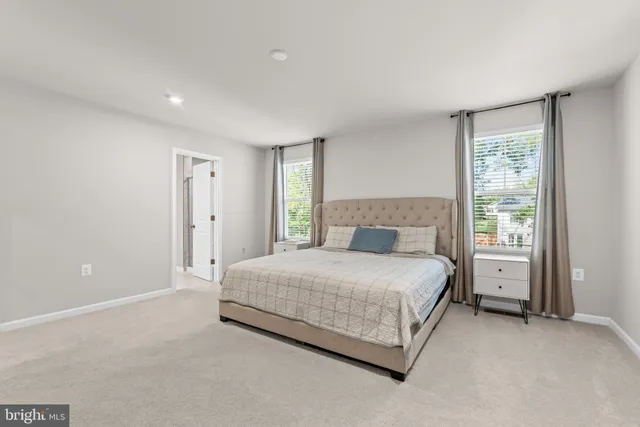 a spacious bedroom with a bed and a window