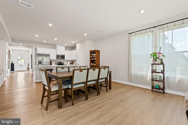 a dining room with furniture and wooden floor