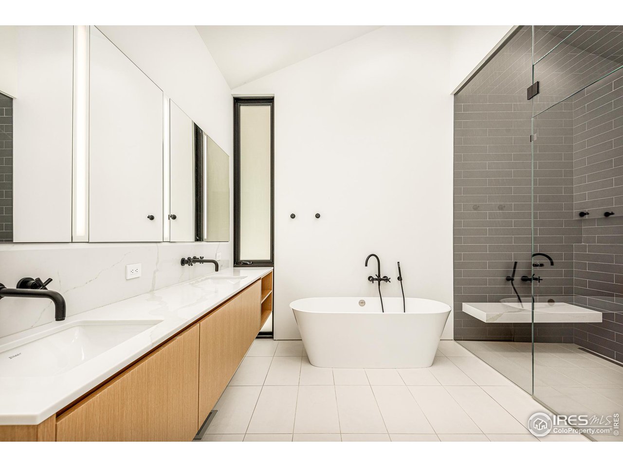 3355 Vista Drive Boulder, CO 80304 - Photo 24 of 40 a bathroom with a double vanity sink bathtub and mirror