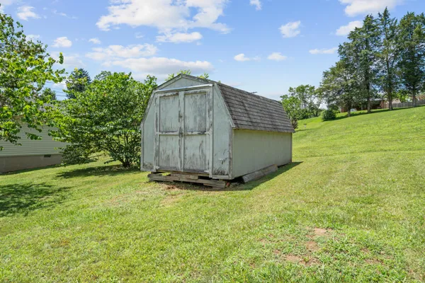 a backyard of a house with yard and trampoline