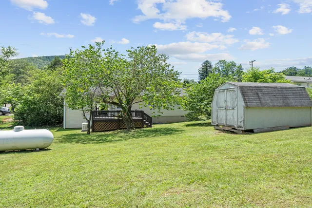 a view of a house with backyard and porch