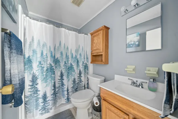 a bedroom with a bed and a chair