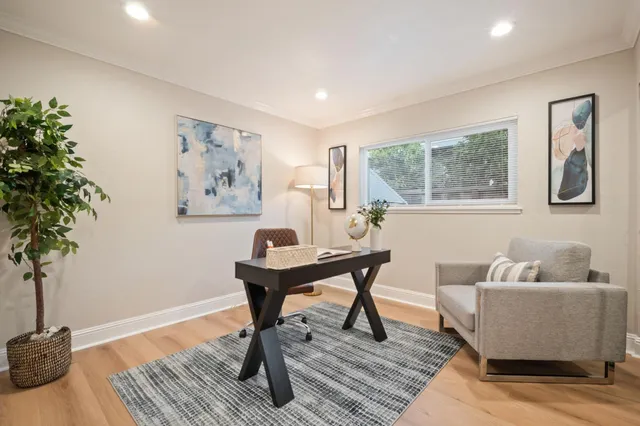 a living room with furniture and a potted plant