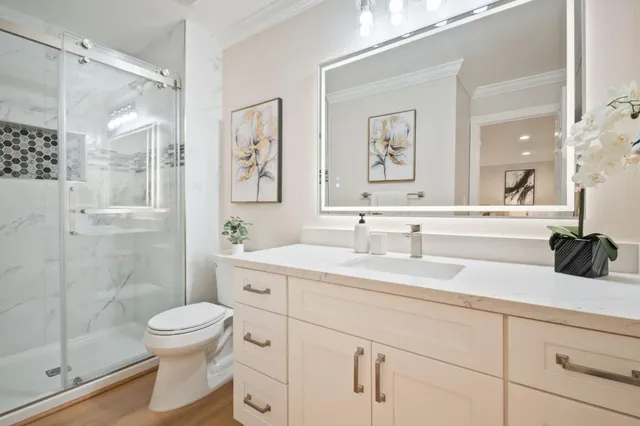 a bathroom with a sink a toilet and shower