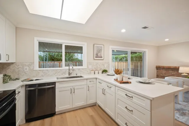 a kitchen with a sink stove and cabinets