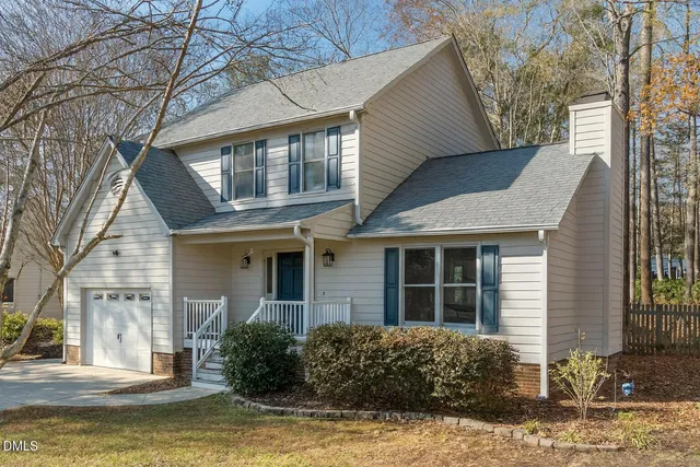 a front view of a house with a yard garage and outdoor seating