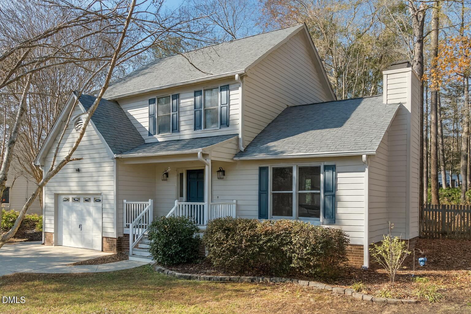 a front view of a house with a yard garage and outdoor seating