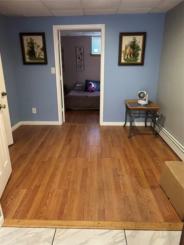 a view of a bedroom with wooden floor and dining table