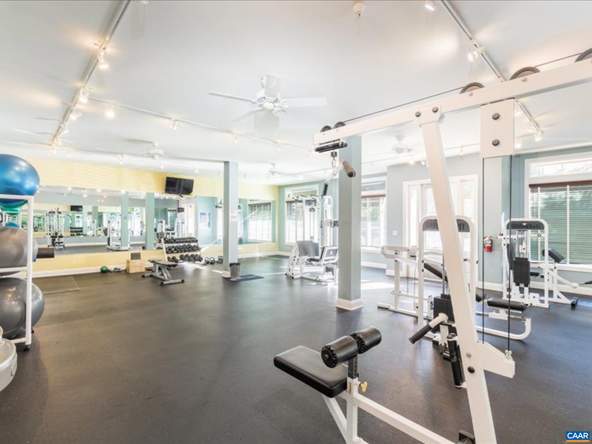 765 Walker Square, Unit 2D Charlottesville, VA 22903 - Photo 29 of 33 a room with gym equipment and large windows