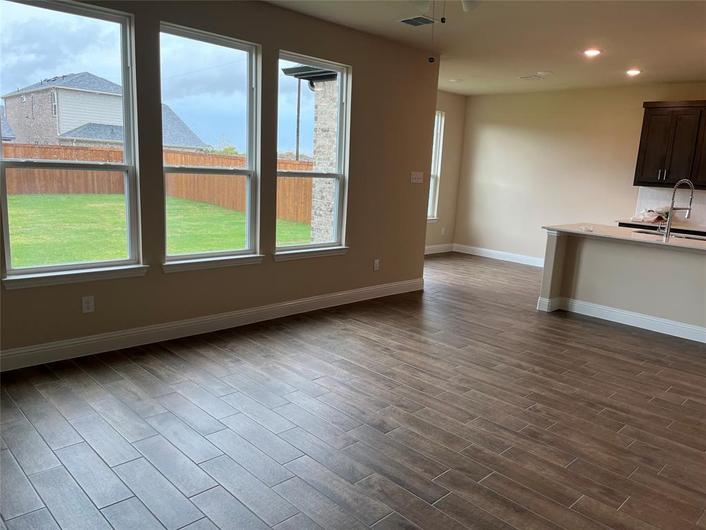 1013 Amendun Lane Anna, TX 75409 - Photo 4 of 19 an empty room with wooden floor and windows