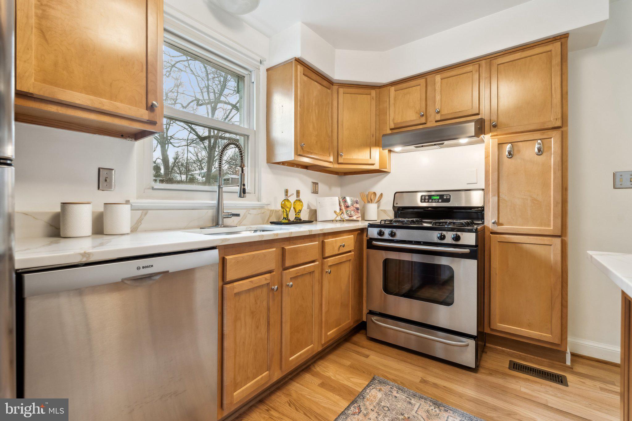9016 Walden Road Silver Spring, MD 20901 - Photo 11 of 59 a kitchen with a sink stove and refrigerator