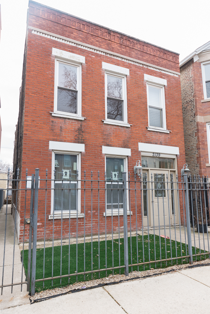 2139 West Huron Street, Unit 1F Chicago, IL 60612 - Photo 1 of 12 a front view of a multi story residential apartment building