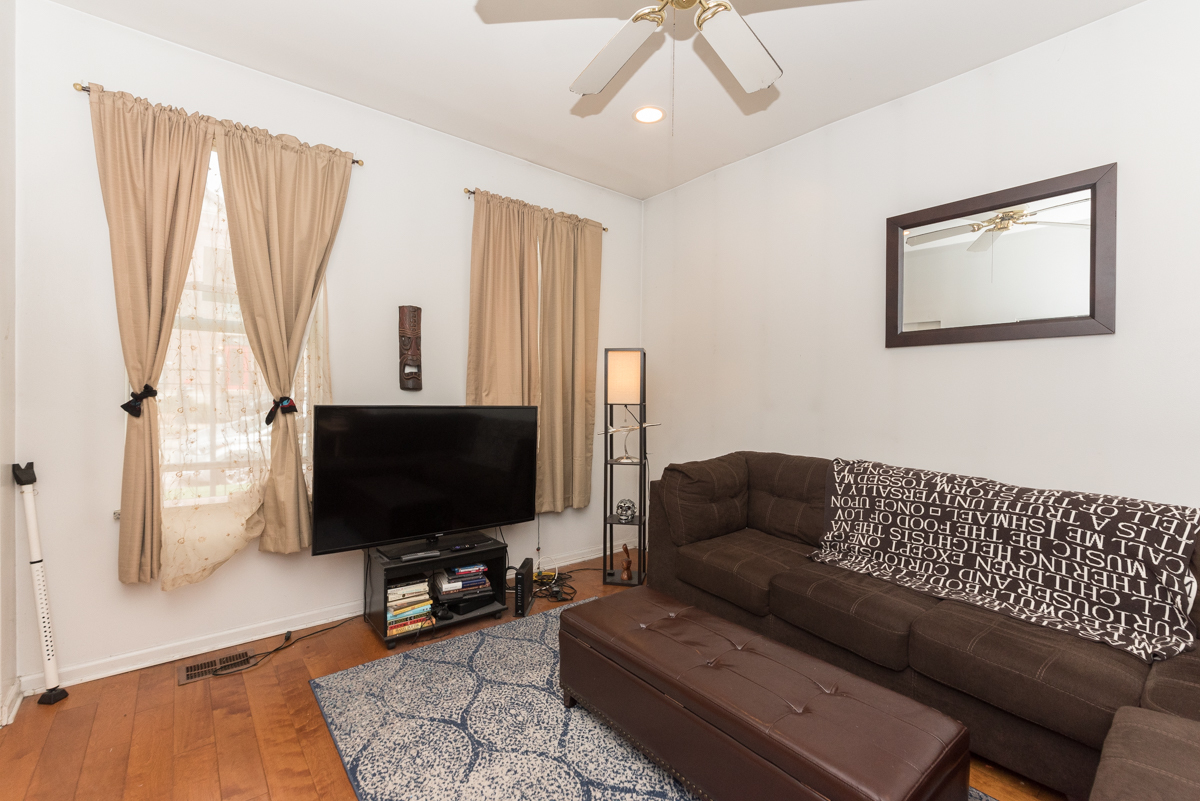 2139 West Huron Street, Unit 1F Chicago, IL 60612 - Photo 3 of 12 a living room with furniture and a flat screen tv