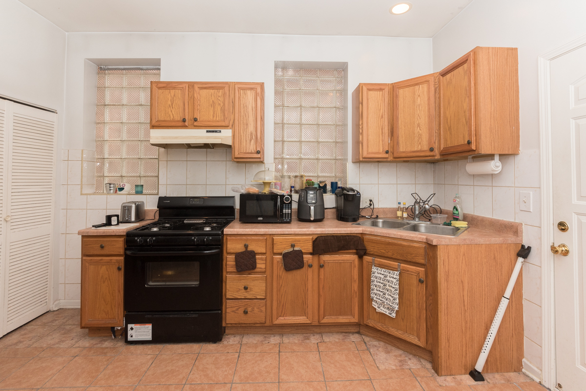 2139 West Huron Street, Unit 1F Chicago, IL 60612 - Photo 6 of 12 a kitchen with stainless steel appliances granite countertop a stove a sink and a refrigerator