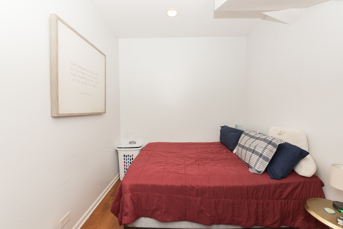 2139 West Huron Street, Unit 1F Chicago, IL 60612 - Photo 9 of 12 a bedroom with a bed and a night stand