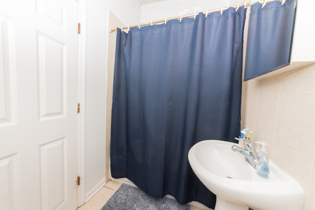 2139 West Huron Street, Unit 1F Chicago, IL 60612 - Photo 10 of 12 a bathroom with a sink and a mirror