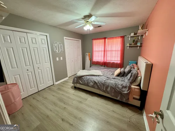 a spacious bedroom with a bed and a chandelier