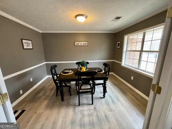 a view of a dining room with furniture and wooden floor