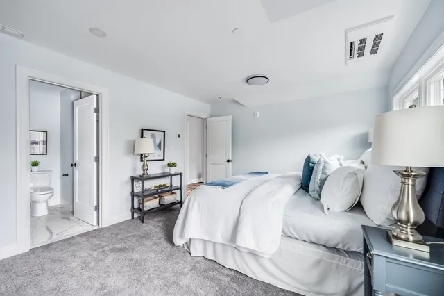 a bed room with a bed and a lamp