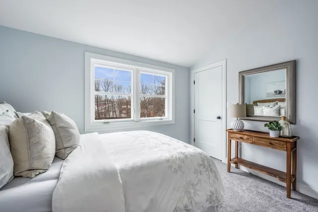 a bedroom with a bed and a dresser in it