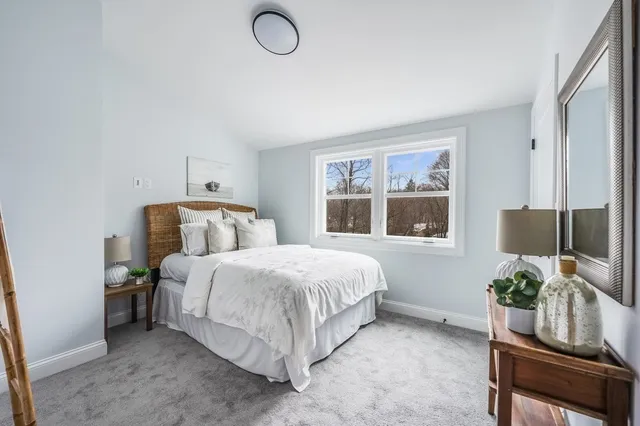 a bedroom with a bed and windows