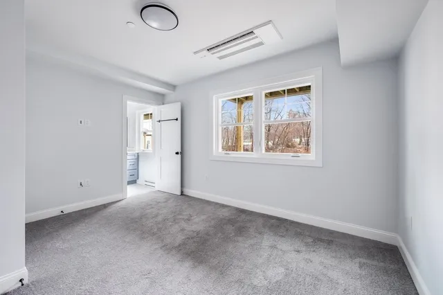 an empty room with windows and closet