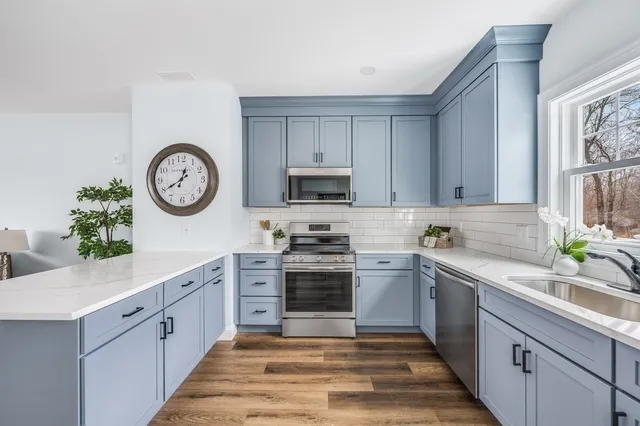 a kitchen with stainless steel appliances granite countertop a stove and a sink