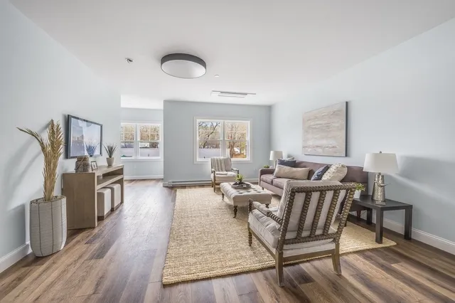 a living room with fireplace furniture and a wooden floor