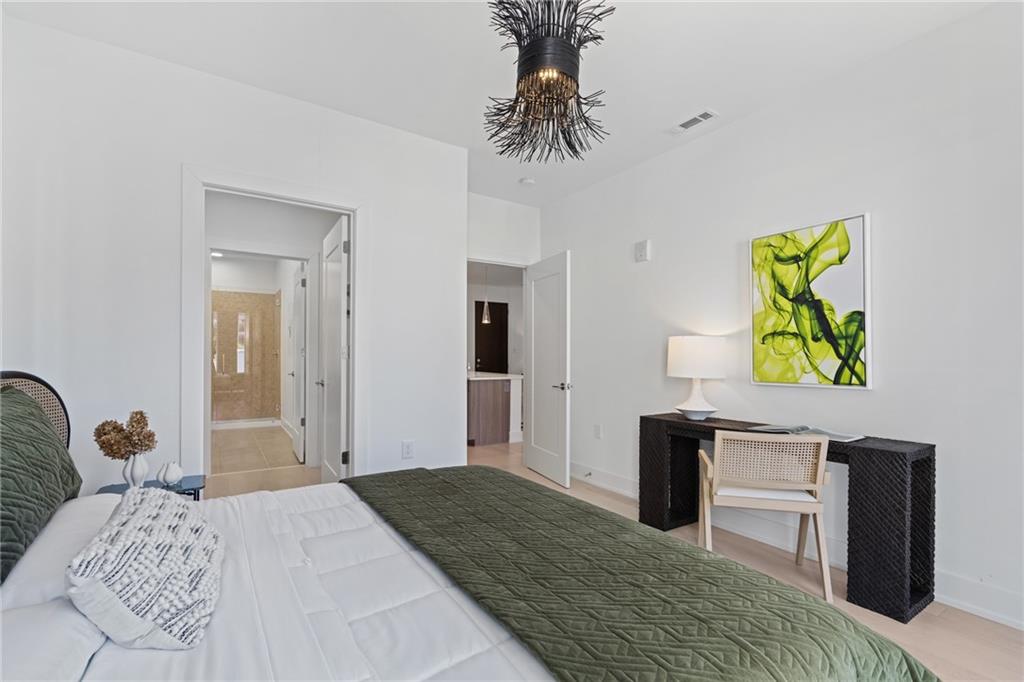 775 Juniper Street Northeast, Unit 227 Atlanta, GA 30308 - Photo 11 of 42 a bedroom with a bed and a dresser