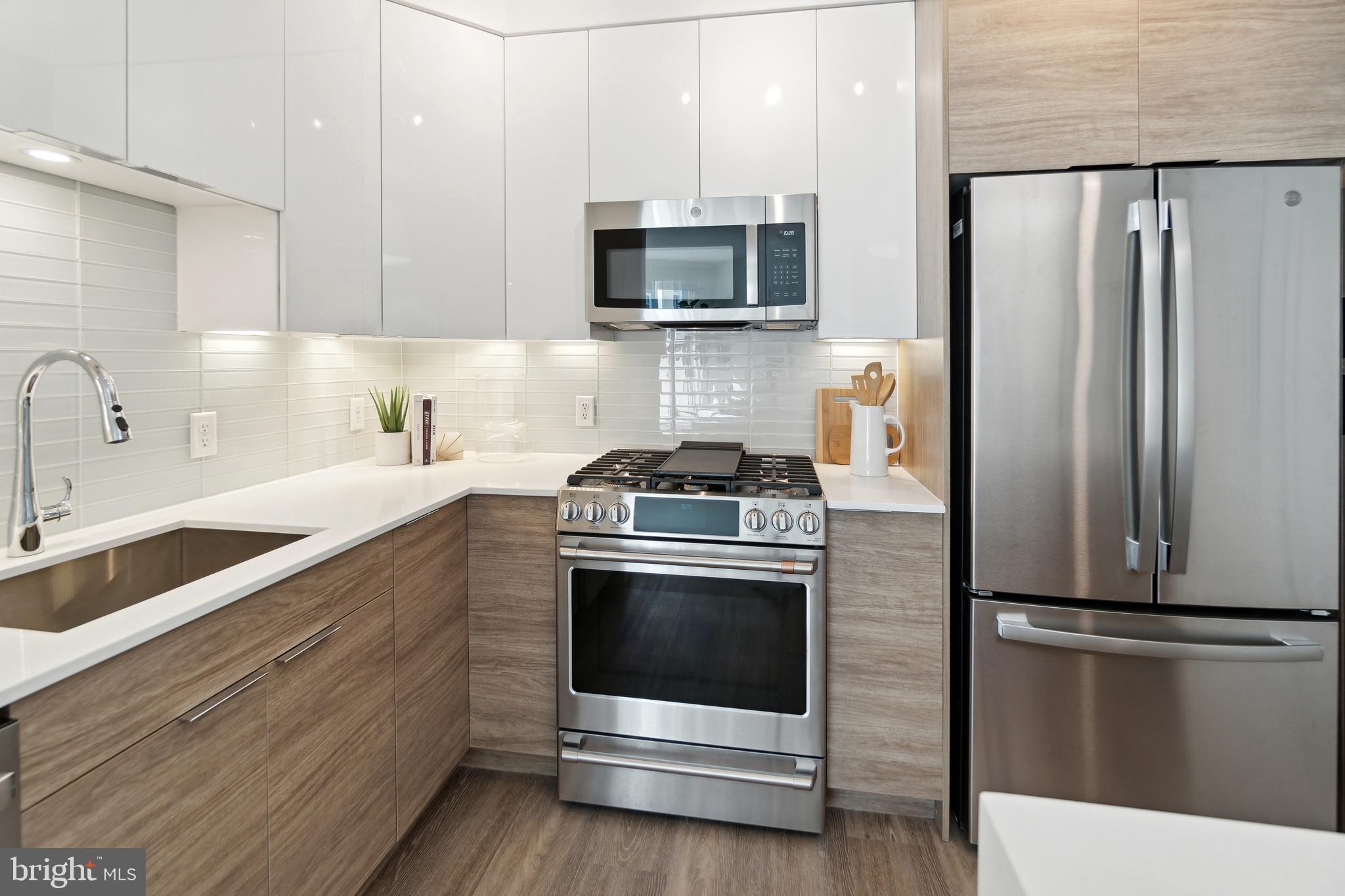 3820 Chaplin Place, Unit 1104/CLAUDE Chevy Chase, MD 20815 - Photo 6 of 26 a kitchen with granite countertop a refrigerator stove and microwave