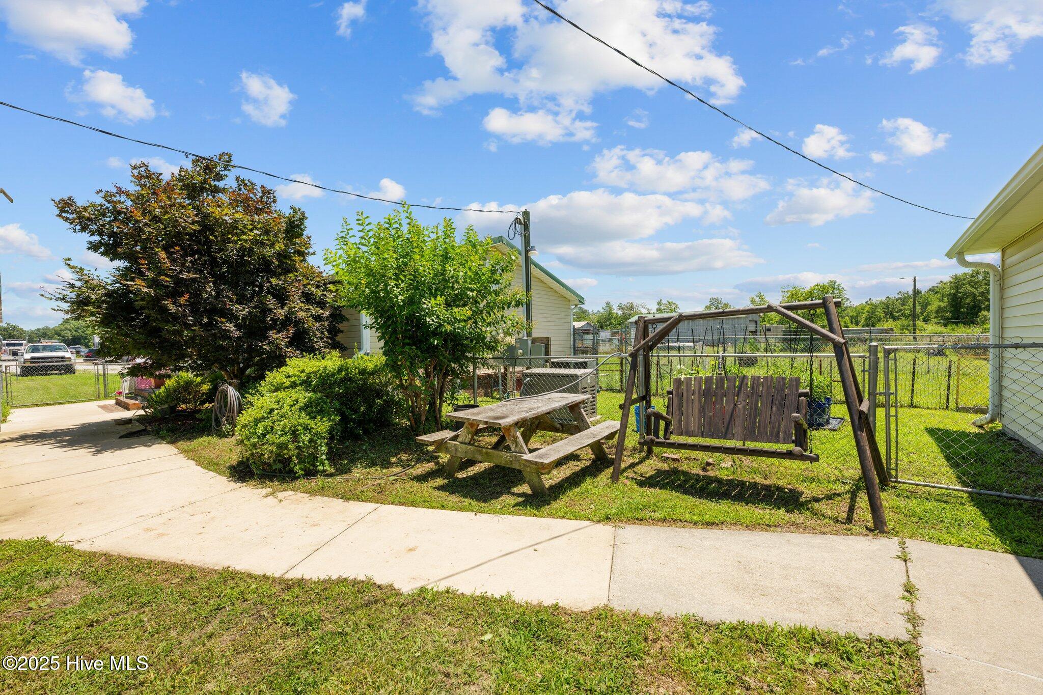 1831 Clarks Road New Bern, NC 28562 - Photo 41 of 82 sidewalk with swing leading to workshop
