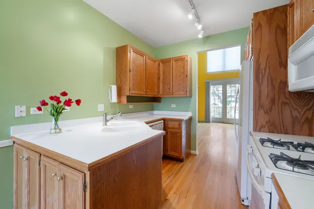 a kitchen with sink refrigerator and stove