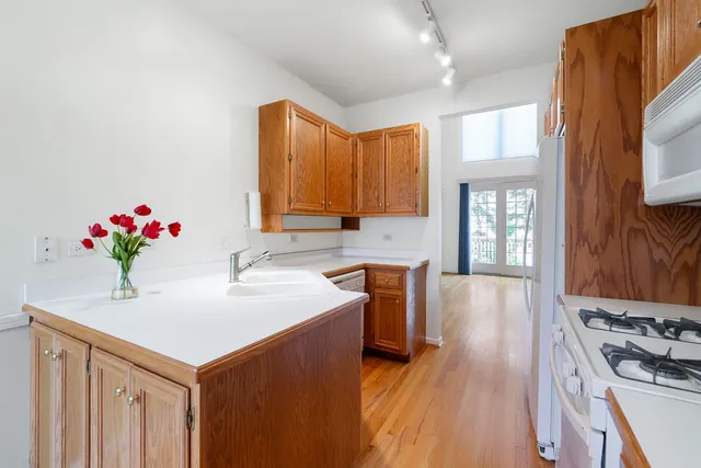 a kitchen with a sink stove and cabinets