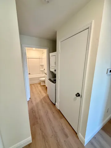 a view of a storage and utility room with refrigerator